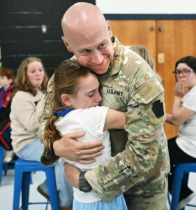 Military dad home from yearlong deployment surprises daughter at school